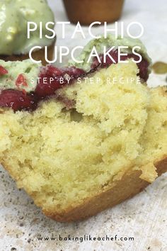 a close up of a piece of cake with berries on it and cupcakes in the background