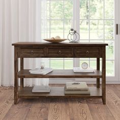 a wooden table with two drawers in front of a window