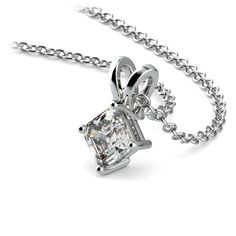 a necklace with a princess cut diamond hanging from it's center link on a chain