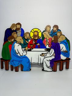 a group of people sitting around a table with the last supper painted on it's side