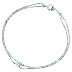 Elegant design crafted in platinum by famed designer Tiffany & Co. The bracelet highlights a double stranded design that leads up to one earth mined natural round brilliant cut diamond weighing 0.17 carat and displaying G color and VVS clarity. The bracelet is fully hallmarked by the designer and measures 6.25" in length and is the medium version of the bracelet. This bracelet will arrive to you like "new" with full inner and outer boxes from Tiffany & Co. All photos taken under magnification, bid confidently. 100% authentic. Tiffany Co Rings, Tiffany And Co Bracelet, Designer Bracelet, Louis Comfort Tiffany, Japan Design, Tiffany Co Jewelry, Solitaire Diamond, Double Ring, Tiffany And Co