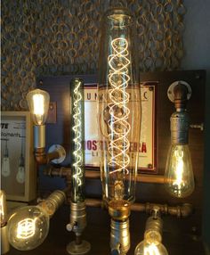 an assortment of light bulbs and lamps on a table with a sign in the background