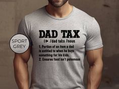 a man wearing a t - shirt with the words dad tax printed on it in black