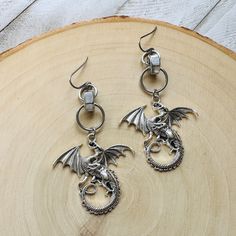 These dragon earrings are the perfect witchy emo jewelry! They would make a great dragon lover gift or metalhead gifts! These silver goth men earrings would also make a great Mother's Day gift from a daughter.  This is a pair of lovely dragon earrings that I made using metal alloy dragon pieces, hypoallergenic surgical steel ear wires, stainless steel hex bolts, and stainless steel jump rings.  Earrings are made with nickel and lead free ear wires.  All orders ship the next business day.  ...... Punk Style Drop Earrings As Gift, Punk Style Drop Earrings For Gift, Handmade Punk Drop Earrings, Silver Fantasy Earrings For Halloween, Fantasy Style Pierced Cartilage Earrings For Gift, Silver Punk Earrings As A Gift, Punk Style Plug Drop Earrings Gift, Punk Drop Plug Earrings, Punk Style Drop Plug Earrings