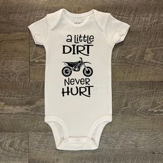 A Little Dirt Never Hurt This listing is for one (1) white bodysuit with black vinyl on the front. Available in short sleeve.  Available Sizes:  Newborn 3 Month 6 Month 9 Month 12 Month 18 Month I hand make each bodysuit, no two will be exactly the same, please allow 3-7 days for production. Please email me with any questions.  Want to see more, check us out on Facebook at http://www.facebook.com/williamandwesley and Instagram @williamandwesleyapparel Thank you for shopping! Cute Short Sleeve White Cotton Bodysuit, Cute White Cotton Short Sleeve Bodysuit, White Cotton Cute Short Sleeve Bodysuit, Cute Fitted White Onesie, Cute White Fitted Onesie, White Short Sleeve Cotton Bodysuit, White Unisex Short Sleeve Onesie, Cute White Fitted Short Sleeve Bodysuit, Unisex White Short Sleeve Cotton Bodysuit