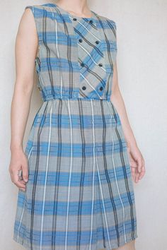 "Made in Japan. ➸ Sleeveless checker / plaid white and blue dress with light gray-beige tones. It has front button closures (4), front zipper, front hidden button fasteners (4 in button style, 1 regular). Skirt part is lined, top part is just very slightly sheer (still work appropriate). *Please note: The dress was slightly pinned on the model. -Brand/tag: Chigusa Bowbell -Material: 35% polyester; 65% triacetate fibre -Care: Dry cleaning (recommended) ➸ CONDITION Excellent condition. ✂ - - - - - Vintage Sleeveless Plaid Summer Dress, Plaid Summer Dress With Button Closure, Vintage Sleeveless Plaid Dress, Casual Blue Plaid Dress For Daywear, Vintage Sleeveless Spring Plaid Dress, Vintage Plaid Sleeveless Dress, Casual Gingham Plaid Dress With Buttons, Sleeveless Plaid Dress For Spring, Plaid Sleeveless Dress For Picnic