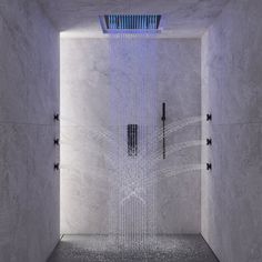 a shower head in the middle of a room with water coming from it's faucet