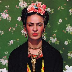 an old photo of a woman with flowers on her head and necklaces around her neck