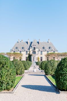 a large house with lots of trees in front of it