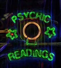 the psychic readings neon sign is lit up