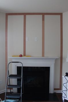 a living room with a fire place next to a wall that has stripes painted on it