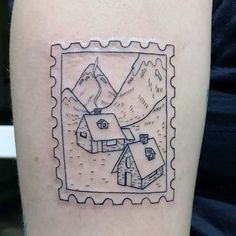 a stamp with a small house and mountains on it's left side calf sleeve