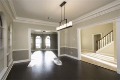 an empty living room with hard wood floors and white trim on the walls is shown