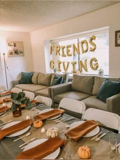 a living room filled with lots of furniture next to a table covered in plates and place settings