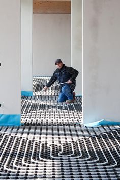 a man kneeling down on top of a floor covered in black and white tiles,