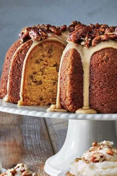 a bundt cake with walnuts and icing on top