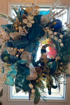 a christmas wreath hanging from the side of a window