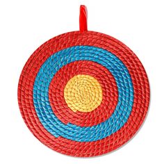 a red, yellow and blue round basket with handles on a white background for use as an ornament