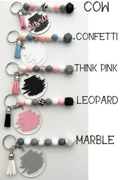 three different key chains with the words confetti, think pink and leopard marble