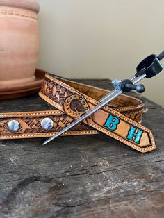 "This children's belt is handmade and will last a lifetime. Hand cut and tooled, stained with saddle tan. It has been sealed with a water resistant sealer to protect it from everyday wear and tear. This belt is sewn with reinforced threads and edge stitched for extra durability and strength. Listing is for belt only. Buckle is not included. Pick your initials and color and your new belt will be made just for you! If you wish to have a personal brand design instead of initials, please send me a m Kids Tool Belt, Karate Belt Display, Personal Brand Design, Custom Belts, Leather Obi Belt, Leather Tool Belt, Custom Leather Belts, Cowgirl Belts, Tooled Leather Belts