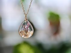 This necklace features Gladiolus, the birth flower for August, carefully preserved in a clear resin pendant. Gladiolus is symbolic of strength of character, faithfulness, moral integrity, and remembrance, making this necklace a perfect personalized birthday gift. Material: 14k gold filled chain and components or Silver, Resin Flower: Real Pressed Flower Chain Length: 18" (45cm)  Pendant Width: 0.79" (2cm) Pendant Height: 0.98" (2.5cm) Every pieces is made by hand and unique, therefore each piece Spiritual Necklaces With Pressed Flowers As Gift, Spiritual Style Necklace With Pressed Flowers As A Gift, Clear Flower-shaped Birth Flower Jewelry, Clear Flower Shaped Birth Flower Jewelry, Nature-inspired Clear Jewelry For Gifts, Clear Nature-inspired Jewelry For Gift, Nature-inspired Clear Jewelry Gift, Clear Flower Pendant Necklace As Gift, Clear Necklaces With Pressed Flowers As A Gift