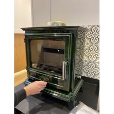 a person is touching an old fashioned stove