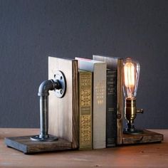 a lamp that is sitting on top of a bookend next to a vase with flowers