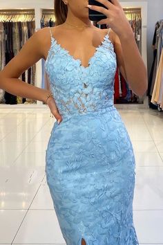 a woman taking a selfie in a blue dress