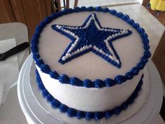 a white and blue cake with a star on it