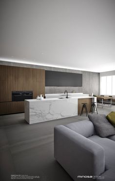 a living room filled with furniture and a large white counter top next to a kitchen