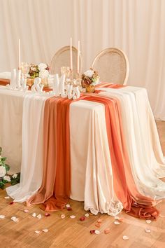 the table is set with candles, flowers and napkins for an elegant wedding reception