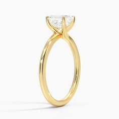 a yellow gold engagement ring with a single diamond on the top and side stones in the middle