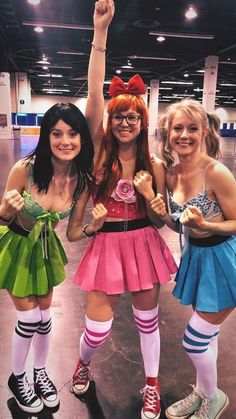 three girls dressed in costumes posing for the camera