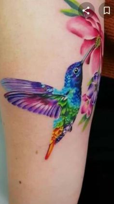 colorful hummingbird with flower tattoo on thigh