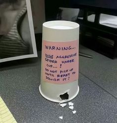 a coffee cup with writing on it sitting in front of a computer monitor and the caption best office prank award goes to