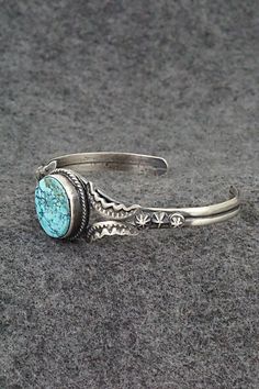 This beautiful natural Kingman turquoise and sterling silver bracelet was made by Navajo silversmith Gilbert Tom. The back is signed Gilbert Tom and stamped sterling.Size: 5 1/2" (will fit up to a 6 1/2" wrist)Gap: 1"Width: 3/4"Cuff Width: 1/4"Free shipping on all orders! We ship with USPS and always include tracking. All orders ship within a day of payment.Returns are accepted up to 30 days after you receive your order. Just send us a message. Our shop offers cash back or store credit. The item must be returned in new condition. Kingman Turquoise, Sterling Silver Bracelet, Native American Jewelry, Turquoise Sterling Silver, Free Jewelry, Sterling Silver Bracelets, Silver Bracelet, Gap, Cuff