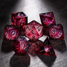 several red dices sitting on top of a table