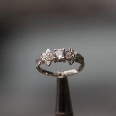 a ring with three small flowers on it