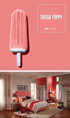 a pink popsicle sitting on top of a wooden floor next to a red wall