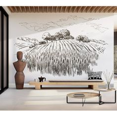 a living room with a large wall mural on it's side and a coffee table in the middle