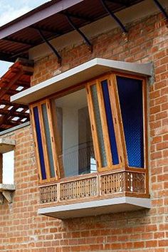 a brick building with an open window and wooden balconies