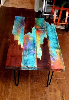 the table is made out of wood and has three different colored paint on it's sides