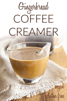 a glass bowl filled with coffee creamer sitting on top of a wooden table