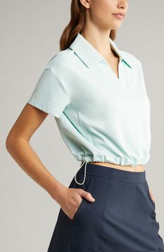 Take your pickleball or tennis game to the next level in this polo-inspired top cut from a superstretchy nylon blend and finished with an adjustable hem. 19 1/2" length (size Medium) Spread collar Short sleeves Drawcord-toggle hem 91% nylon, 9% spandex Machine wash, tumble dry Imported