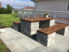 a wooden bench sitting on top of a stone patio