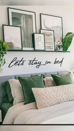 there is a bed with pillows and pictures on the wall above it that says let's stay in bed