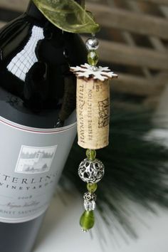 a bottle of wine with a cork and bead hanging from it's side