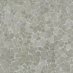 a gray and white tile background with small rocks