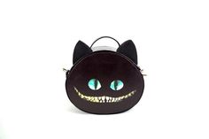 a black cat purse with green eyes and fangs