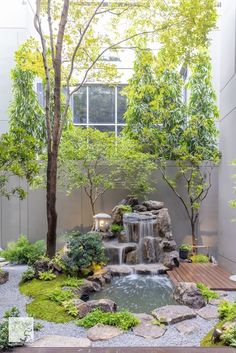 a small waterfall in the middle of a garden